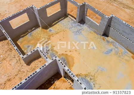 A top view of concrete blocks for a new house foundation constructed by a construction mason 91337823