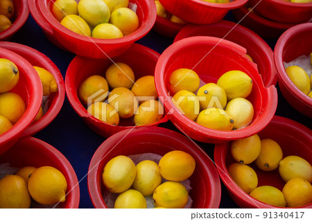Pile of ripe yellow lemons in summer market for sale, for background. Pile of ripe yellow lemons in summer market for sale, for background. 91340417