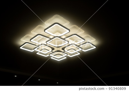 Led lamps built into the ceiling glowing in the dark 91340809