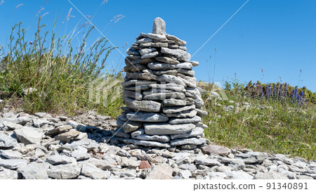 Stone figures on the beach of the Sorve Peninsula in the Ojessaare Nature Reserve. Estonia, Saaremaa. Horizon over sea in summer time. Pebble beach. Stone figures on the beach of the Sorve Peninsula in the Ojessaare Nature Reserve. Estonia, Saaremaa. Horizon over sea in summer time. Pebble beach. 91340891