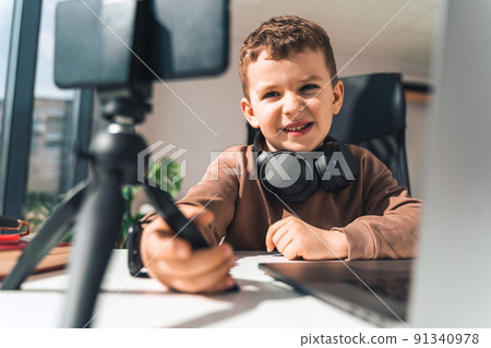 Boy is studying online at laptop Boy is studying online at laptop 91340978