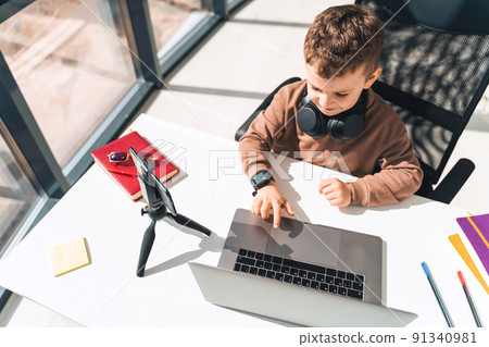Boy is studying online at laptop Boy is studying online at laptop 91340981