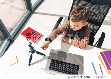 Boy is studying online at laptop Boy is studying online at laptop 91340982