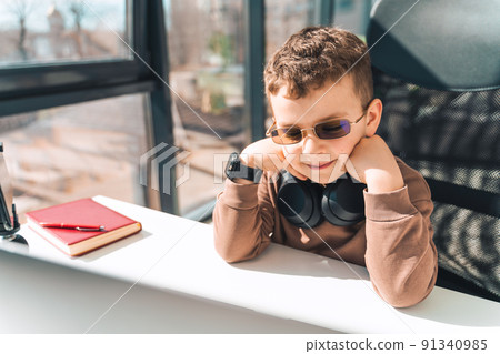 Schoolboy watches online video lessons on laptop. Studying during an epidemic Schoolboy watches online video lessons on laptop. Studying during an epidemic 91340985