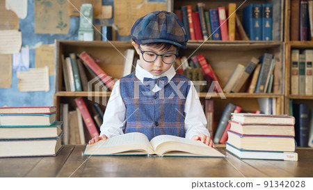 A boy reading a book in the library 91342028