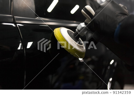 Car body polishing process at the detailing workshop. 91342359