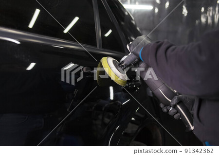 Car body polishing process at the detailing workshop. 91342362