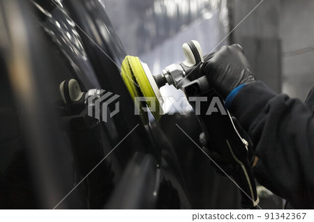 Car body polishing process at the detailing workshop. 91342367