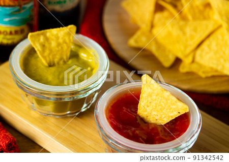 Tortilla chips and dip sauce Tortilla chips and dip sauce 91342542