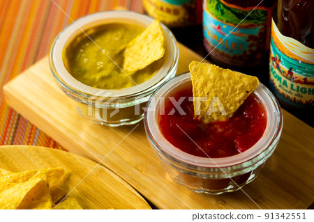 Tortilla chips and dip sauce Tortilla chips and dip sauce 91342551