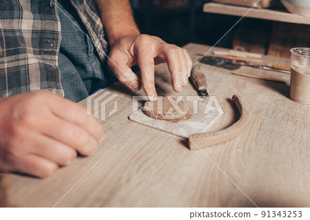 Potter forms clay creating a cup. Potter forms clay creating a cup. 91343253