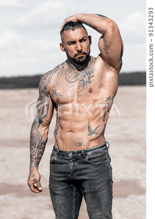 Sexy portrait of muscular handsome topless male model at the beach Sexy portrait of muscular handsome topless male model at the beach 91343293