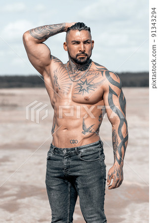 Sexy portrait of muscular handsome topless male model at the beach Sexy portrait of muscular handsome topless male model at the beach 91343294