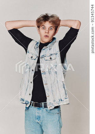 surprised young handsome guy on gray background. surprised young handsome guy on gray background. 91345744