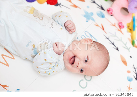 newborn baby in crib with toys at home newborn baby in crib with toys at home 91345845