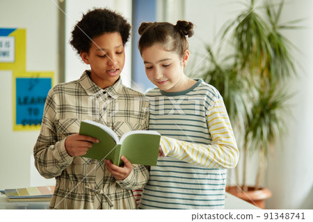 Girls Reading Book to Class 91348741