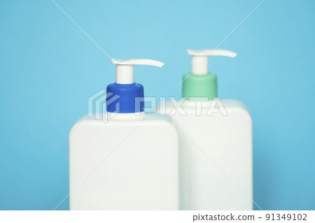 Shampoo or hair conditioner bottles with dispenser pump on blue background. 91349102