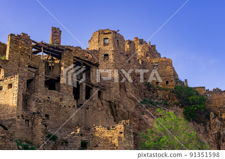 ruins of houses on a cliff in the abandoned village of Gamsutl, Dagestan 91351598