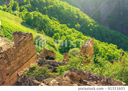 view of a sunny wooded valley from the ruins of a building in the abandoned village of Gamsutl, Dagestan view of a sunny wooded valley from the ruins of a building in the abandoned village of Gamsutl, Dagestan 91351603