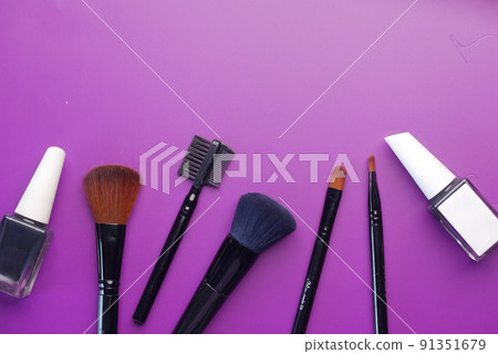 top view of decorative black color cosmetic on dark background  91351679