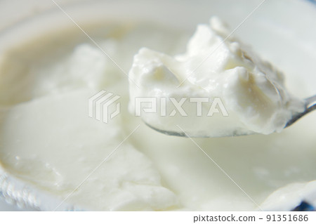 fresh yogurt in a bowl on table  91351686