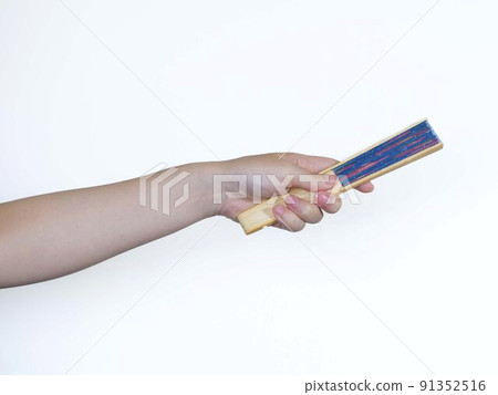 Hand holding a fan Hand holding a fan 91352516