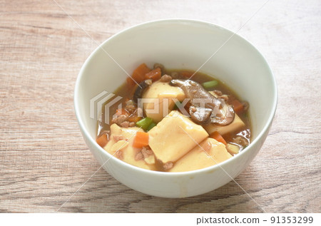 fried egg tofu with chop pork topping slice mushroom in sweet and sour gravy sauce on bowl 91353299