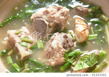 hot and spicy pork bone with tamarind and Thai herbs soup on bowl  91353301