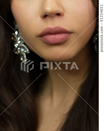 Cosmetics, makeup and trends. Bright lip gloss and lipstick on lips. Closeup of beautiful female mouth with natural lip makeup. Beautiful part of female face. Perfect clean skin 91354651