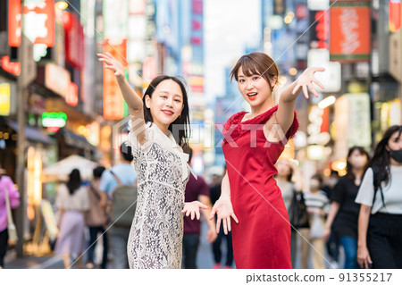 Two women posing in downtown Two women posing in downtown 91355217