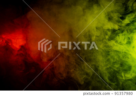 Red-yellow smoke spreads on a black background. 91357980