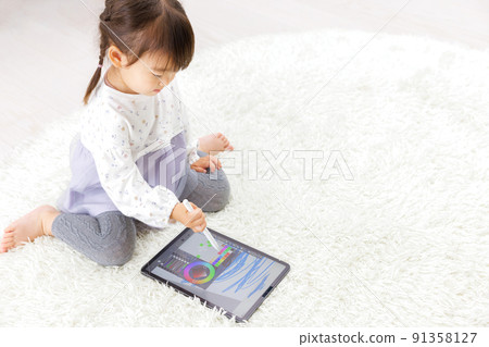 Toddler drawing on a tablet 91358127