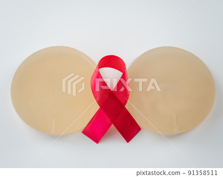 Breast implants and satin ribbon. Breast cancer awareness symbol. Breast implants and satin ribbon. Breast cancer awareness symbol. 91358511