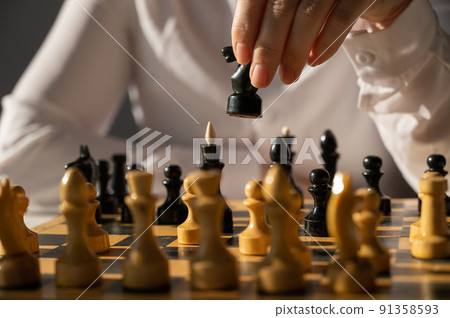 Faceless caucasian woman in white shirt playing chess. Faceless caucasian woman in white shirt playing chess. 91358593