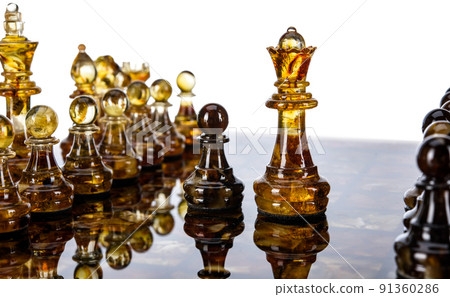 Natural amber different chess pieces figures standing on brown stone board. Close up game concept competition, Classic Gambit Tournament of confrontation. 91360286