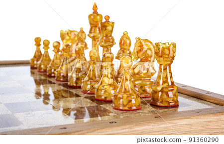 Natural amber different chess pieces figures standing on brown stone board. Close up game concept competition, Classic Gambit Tournament of confrontation. Natural amber different chess pieces figures standing on brown stone board. Close up game concept competition, Classic Gambit Tournament of confrontation. 91360290