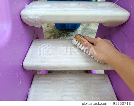 scrubbing brush cleaning on the stairs of children's toys. 91360718
