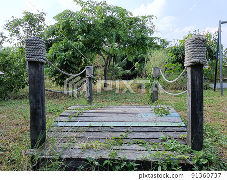 small wooden bridge in garden a beautiful green area for children to run and play. small wooden bridge in garden a beautiful green area for children to run and play. 91360737