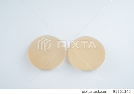 Breast implants on a white background. Plastic surgery. Breast implants on a white background. Plastic surgery. 91361343