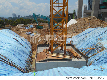 SELANGOR, MALAYSIA -MAY 2, 2022: Building foundation work is being carried out at the construction site. The building uses the bore pile and pile cap method. Workers are busy at the construction site. 91364597