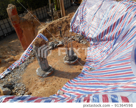 SELANGOR, MALAYSIA -MAY 2, 2022: Building foundation work is being carried out at the construction site. The building uses the bore pile and pile cap method. Workers are busy at the construction site. SELANGOR, MALAYSIA -MAY 2, 2022: Building foundation work is being carried out at the construction site. The building uses the bore pile and pile cap method. Workers are busy at the construction site. 91364598