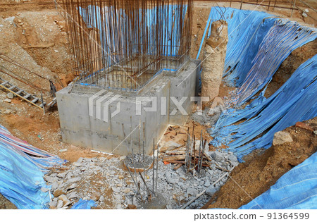 SELANGOR, MALAYSIA -MAY 2, 2022: Building foundation work is being carried out at the construction site. The building uses the bore pile and pile cap method. Workers are busy at the construction site. 91364599