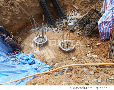 SELANGOR, MALAYSIA -MAY 2, 2022: Building foundation work is being carried out at the construction site. The building uses the bore pile and pile cap method. Workers are busy at the construction site. SELANGOR, MALAYSIA -MAY 2, 2022: Building foundation work is being carried out at the construction site. The building uses the bore pile and pile cap method. Workers are busy at the construction site. 91364600