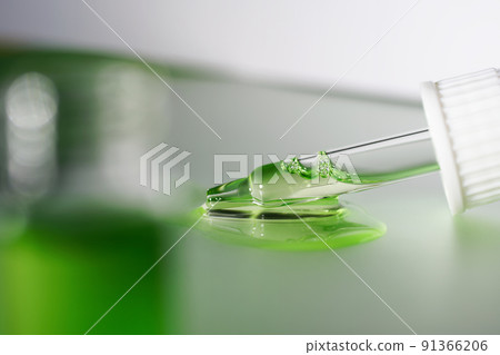 Pipette with fluid serum, oil, face gel cleaner. Cosmetics and healthcare concept closeup. Dose of retinol with air bubbles. Flat lay. Monkeypox, coronavirus research Pipette with fluid serum, oil, face gel cleaner. Cosmetics and healthcare concept closeup. Dose of retinol with air bubbles. Flat lay. Monkeypox, coronavirus research 91366206