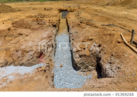 A trench is being dug a concrete foundation for a new house 91369288