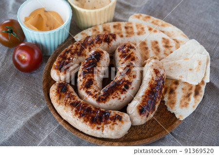 Grilled sausages with sauce and vegetable Grilled sausages with sauce and vegetable 91369520