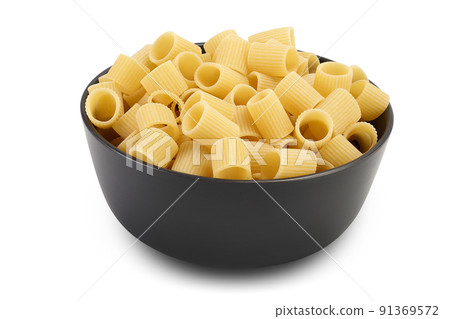 raw italian pasta in ceramic bowl isolated on white background . Mezze Maniche Rigate Bronze die raw italian pasta in ceramic bowl isolated on white background . Mezze Maniche Rigate Bronze die 91369572