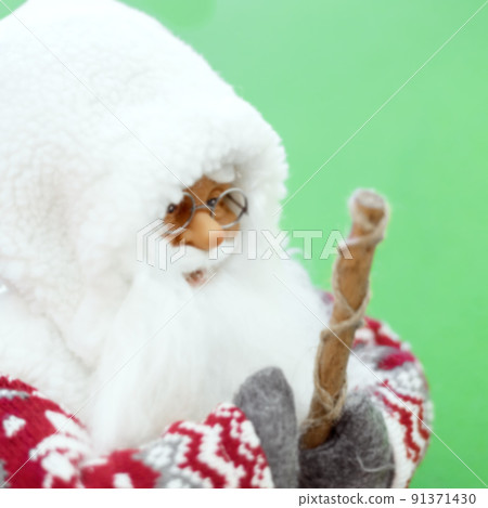 Figurine Scandinavian old gnome with a staff. Defocused image. Closeup photo Figurine Scandinavian old gnome with a staff. Defocused image. Closeup photo 91371430