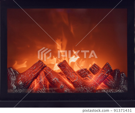 Fireplace with bright flames. Artificial decorative fireplace with imitation of fire. Modern technology for warmth and home comfort. Full screen photo. Front view. Fireplace with bright flames. Artificial decorative fireplace with imitation of fire. Modern technology for warmth and home comfort. Full screen photo. Front view. 91371431