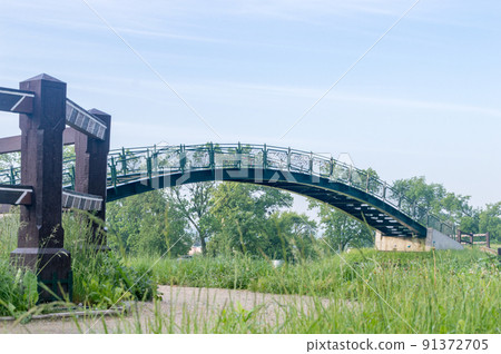Public skywalk bridge with love padlocks over railroad tracks. Public skywalk bridge with love padlocks over railroad tracks. 91372705